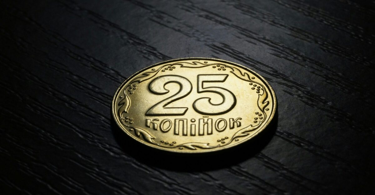 round gold-colored 25 con on black surface