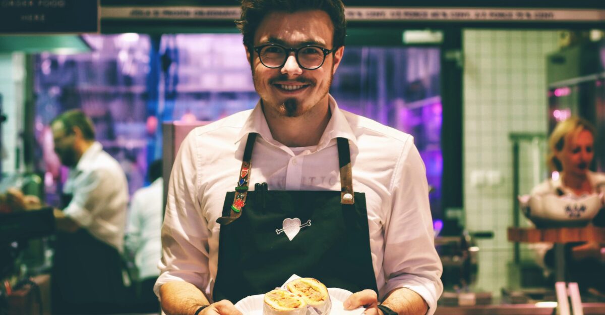 man holding fish dish on plate
