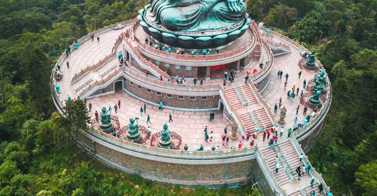 aerial photography of people walking around Bhumishparsha Mudra monument