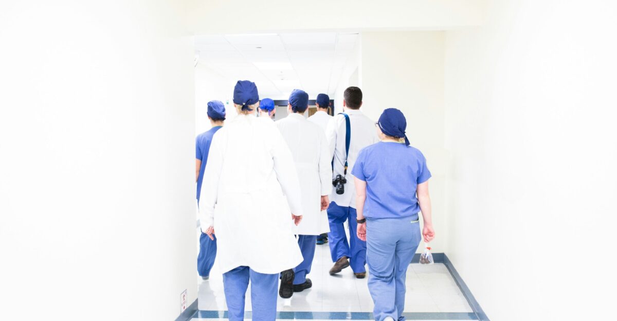 group of doctors walking on hospital hallway