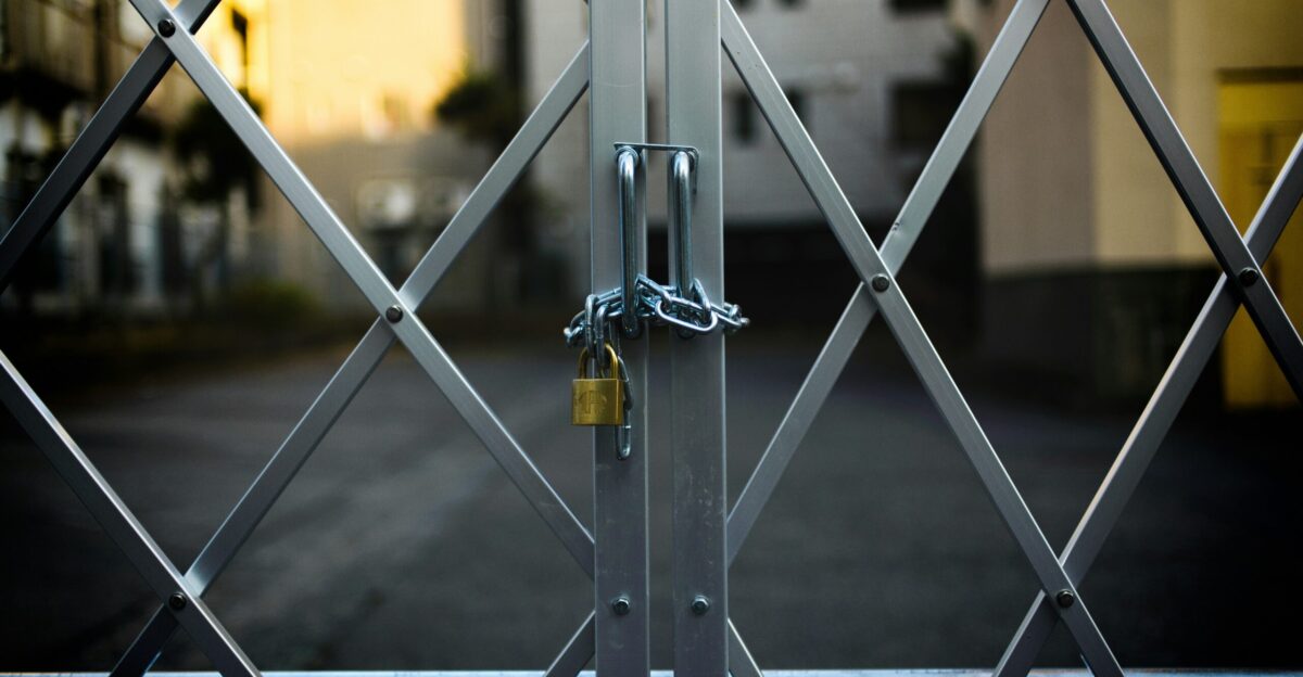 gray steel gate closed with padlock