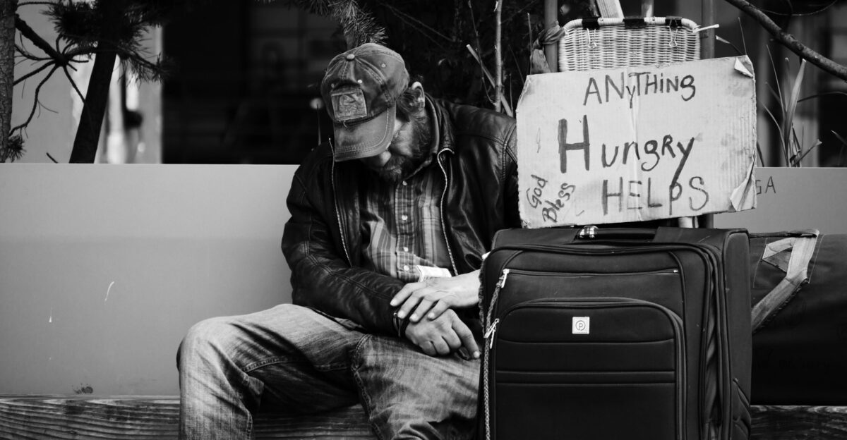grayscale photography of man sitting on chair