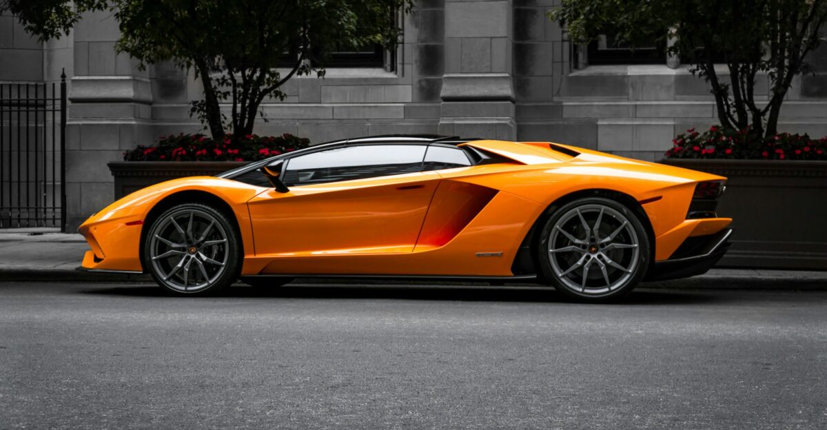 orange sports car on roadway