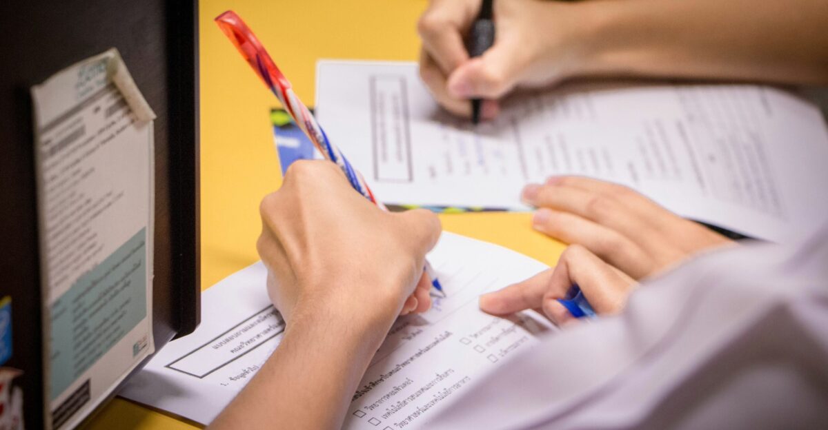 person writing on white paper