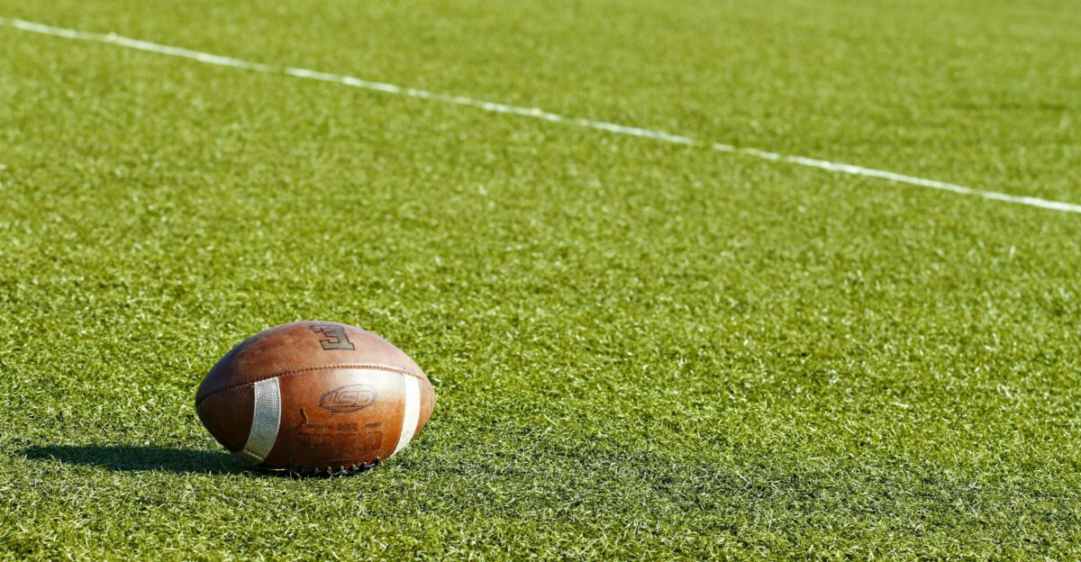 football on green field during daytime