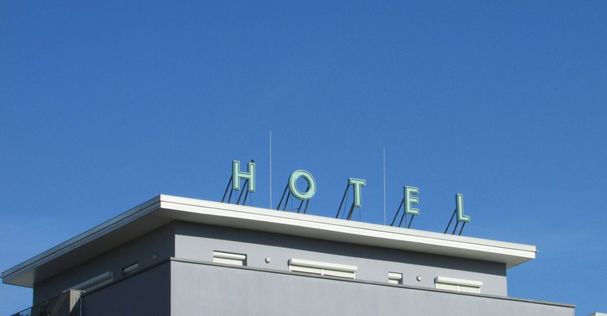 gray and white Hotel signage during daytime