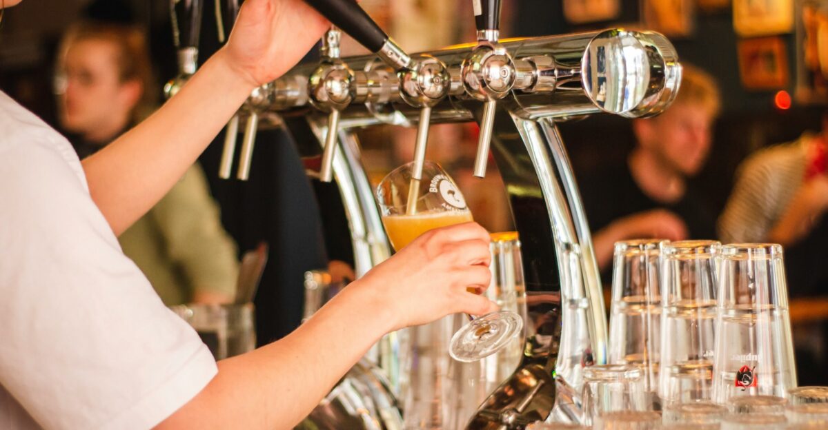 person holding handle of faucet