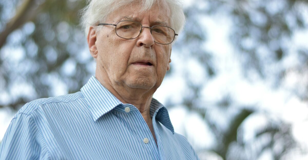selective focus photography of man wearing blue and white striped collared top
