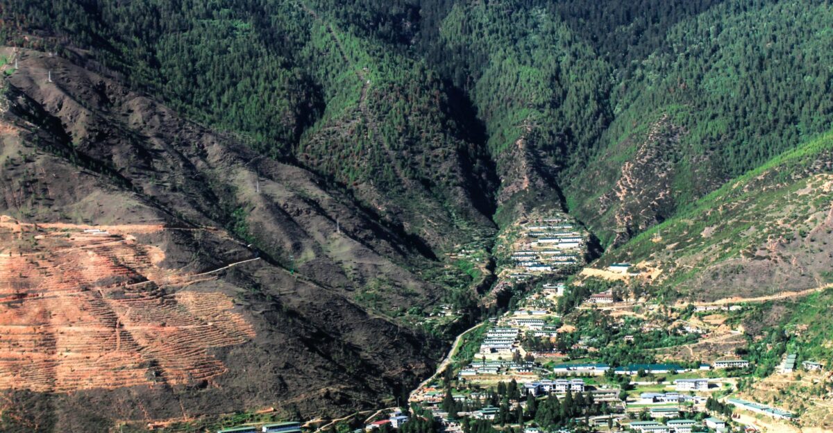 a view of a valley with a mountain in the background