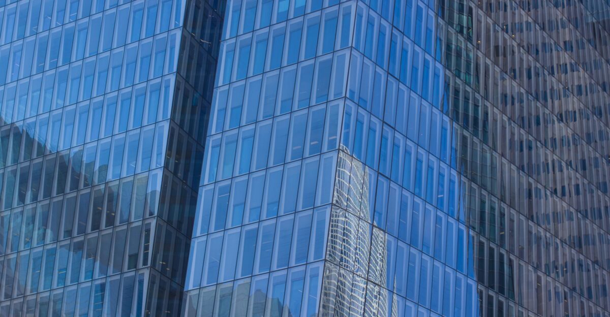 low-angle photography of blue glass walled high-rise building