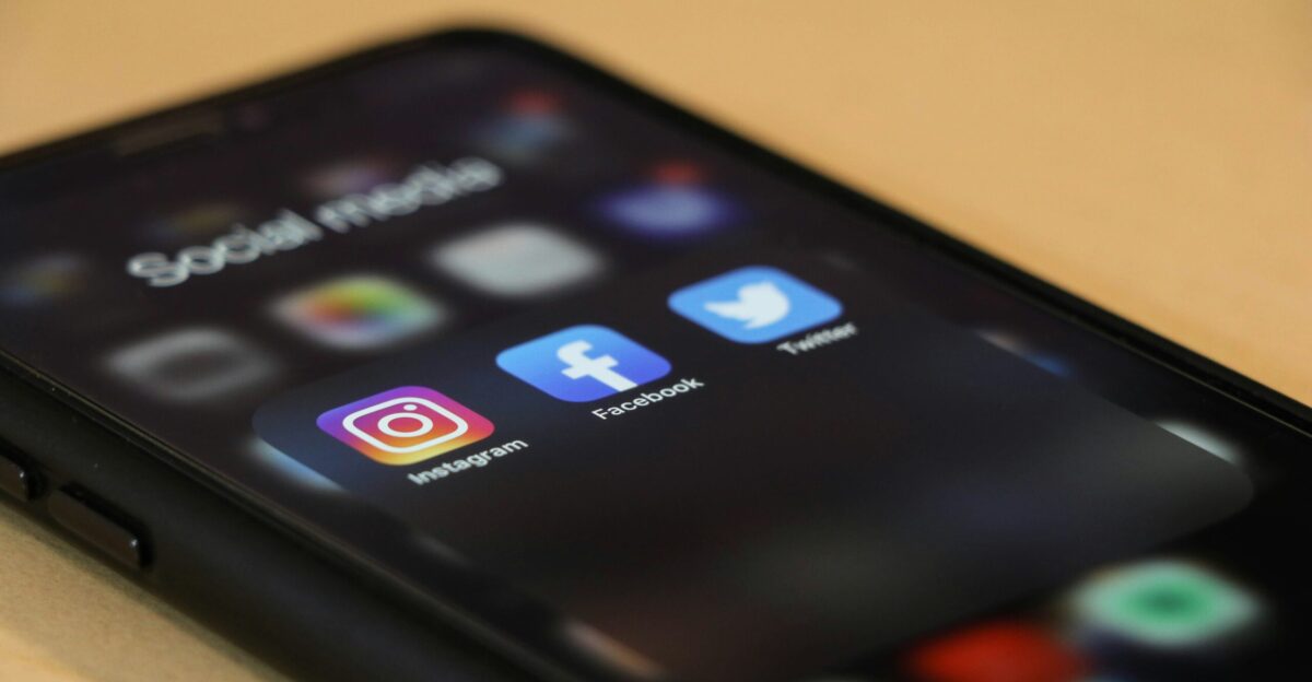 black iphone 4 on brown wooden table