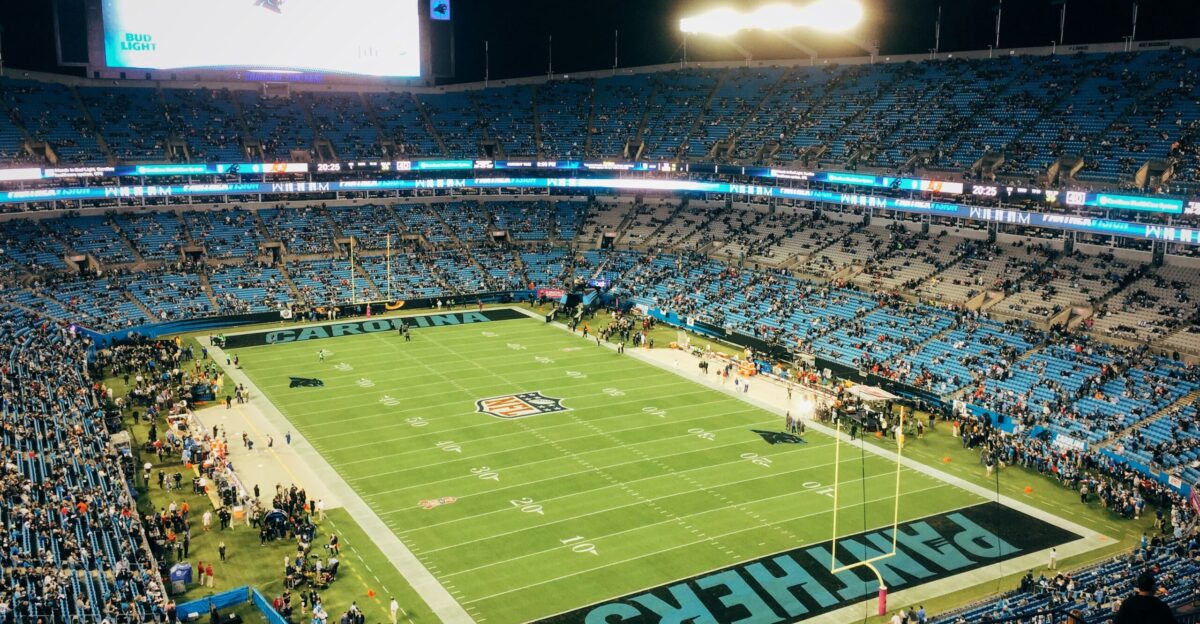 people watching football game during nighttime
