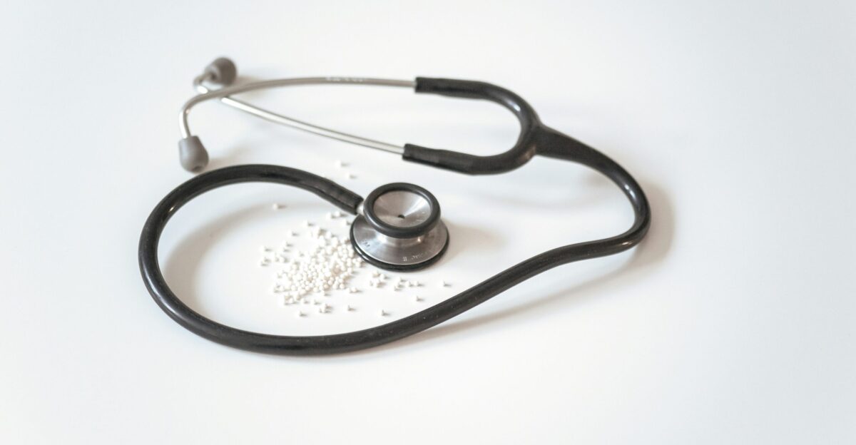 black and silver stethoscope on white surface