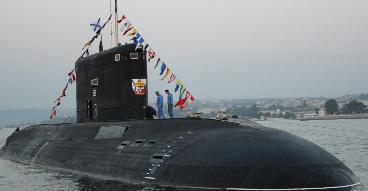 black ship on sea under gray sky during daytime