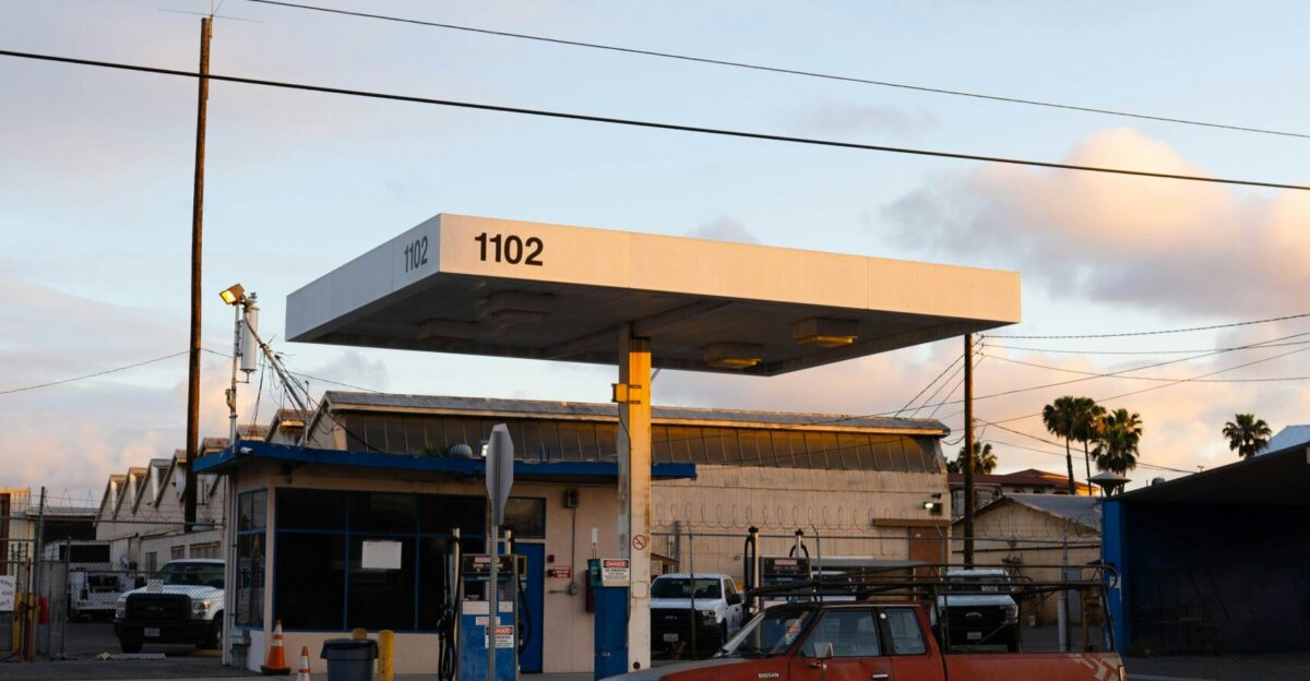 red and black suv parked in front of white and blue building during daytime
