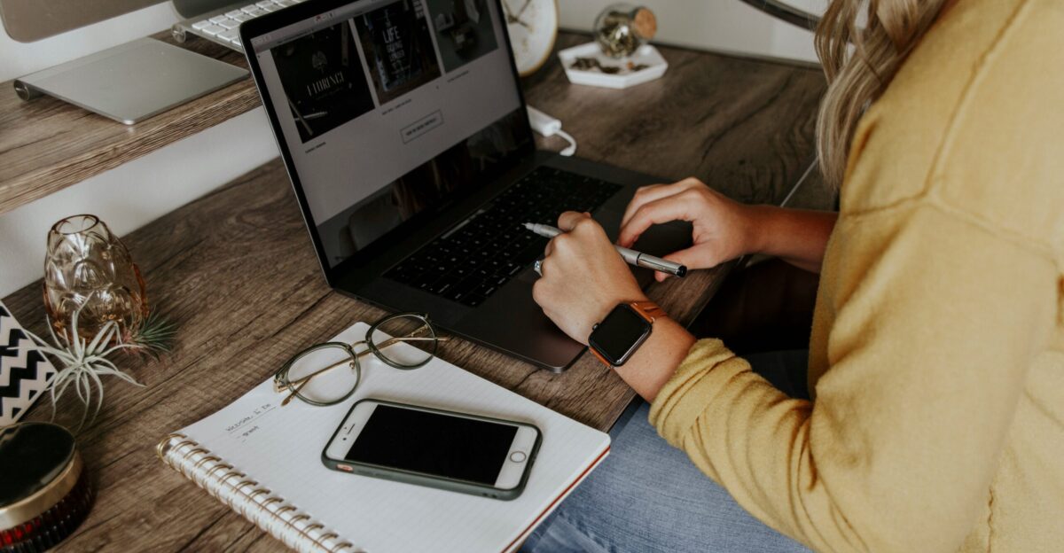 person in blue denim jeans using macbook pro