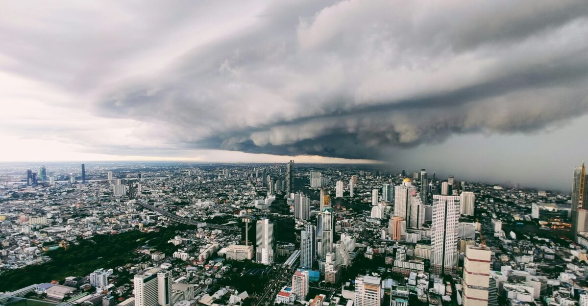 city with high rise buildings under white clouds during daytime