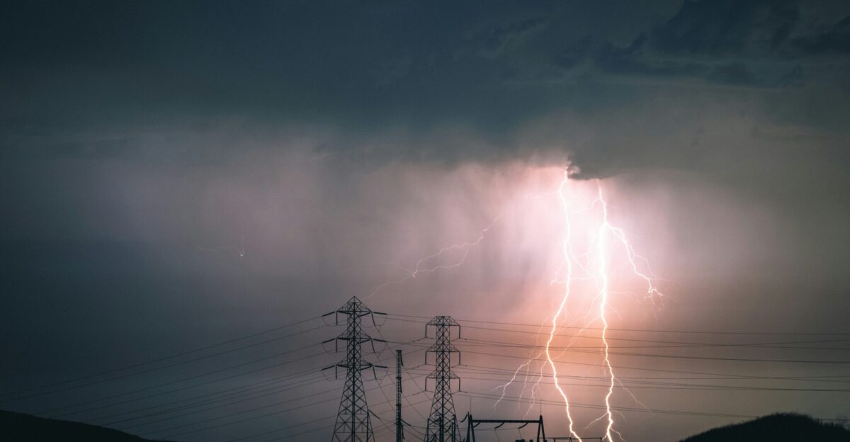 silhouette of electric tower during sunset