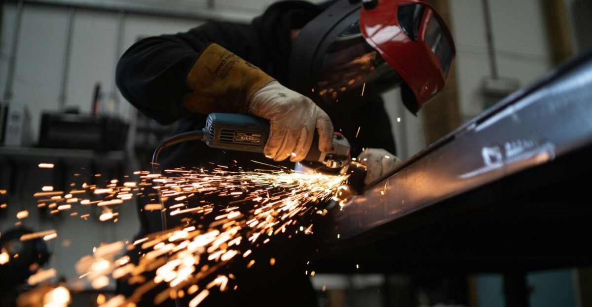 person in black jacket holding brown wooden rolling pin