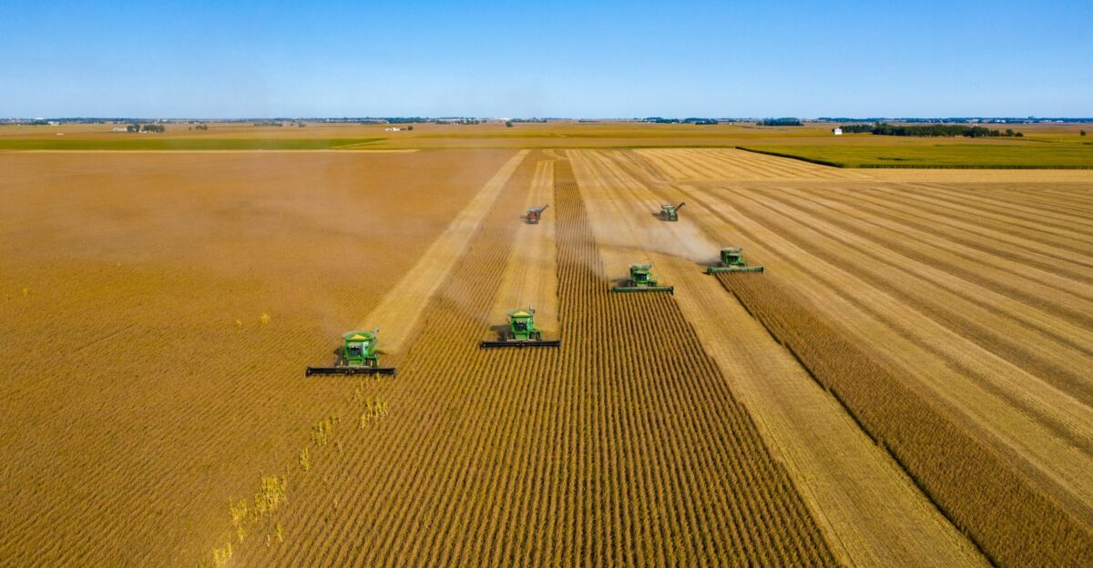 green truck on brown field under blue sky during daytime