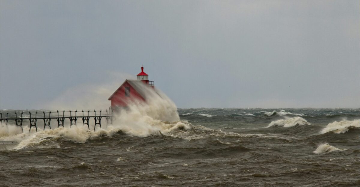 red and white lighthouse on sea water during daytime