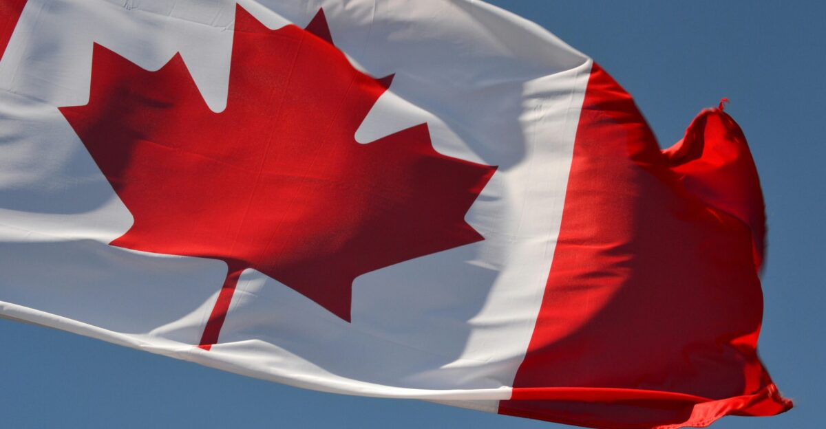 red and white flag under blue sky during daytime