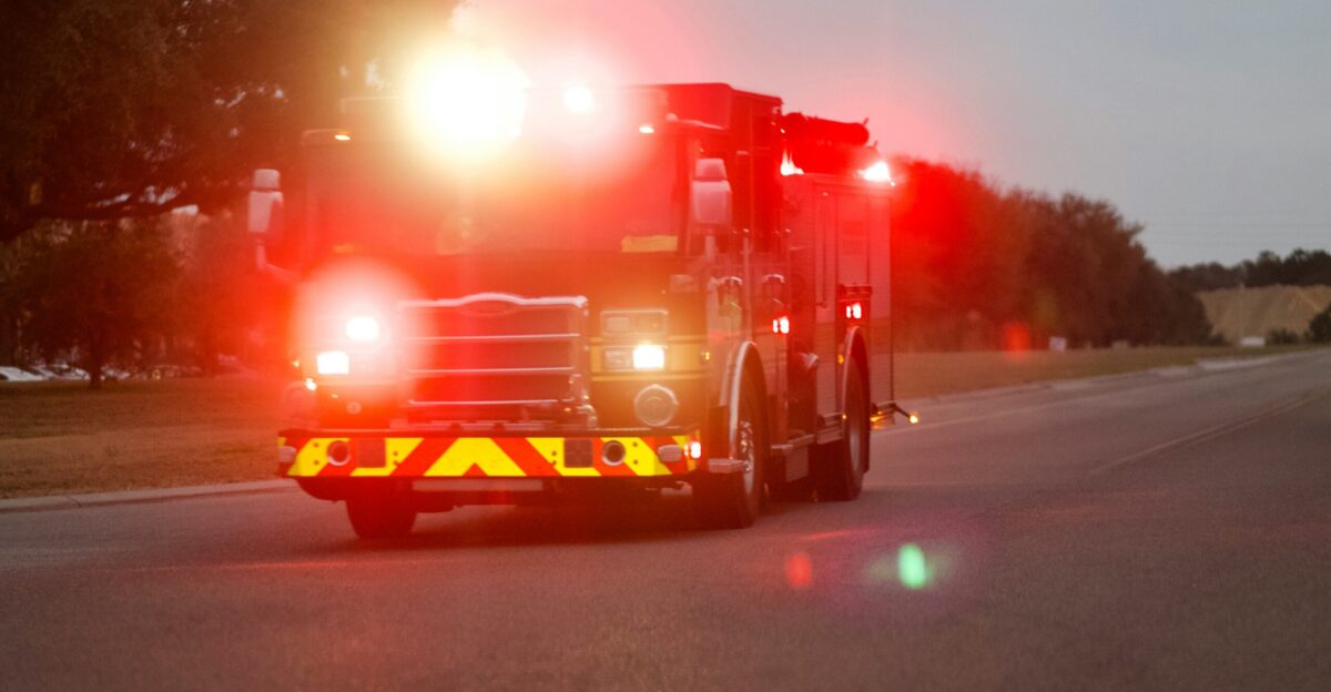 red and white fire truck on road during night time