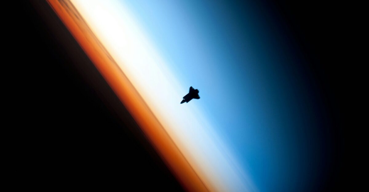 Space Shuttle orbits above earth atmosphere
