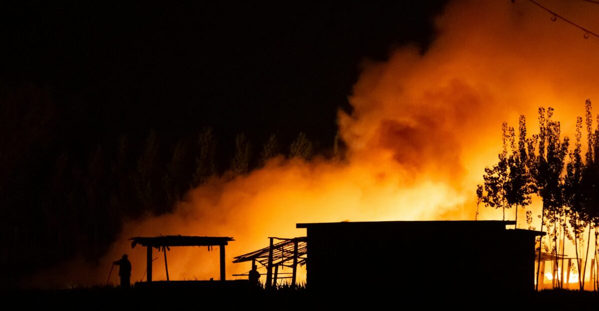 silhouette of man standing on a ladder