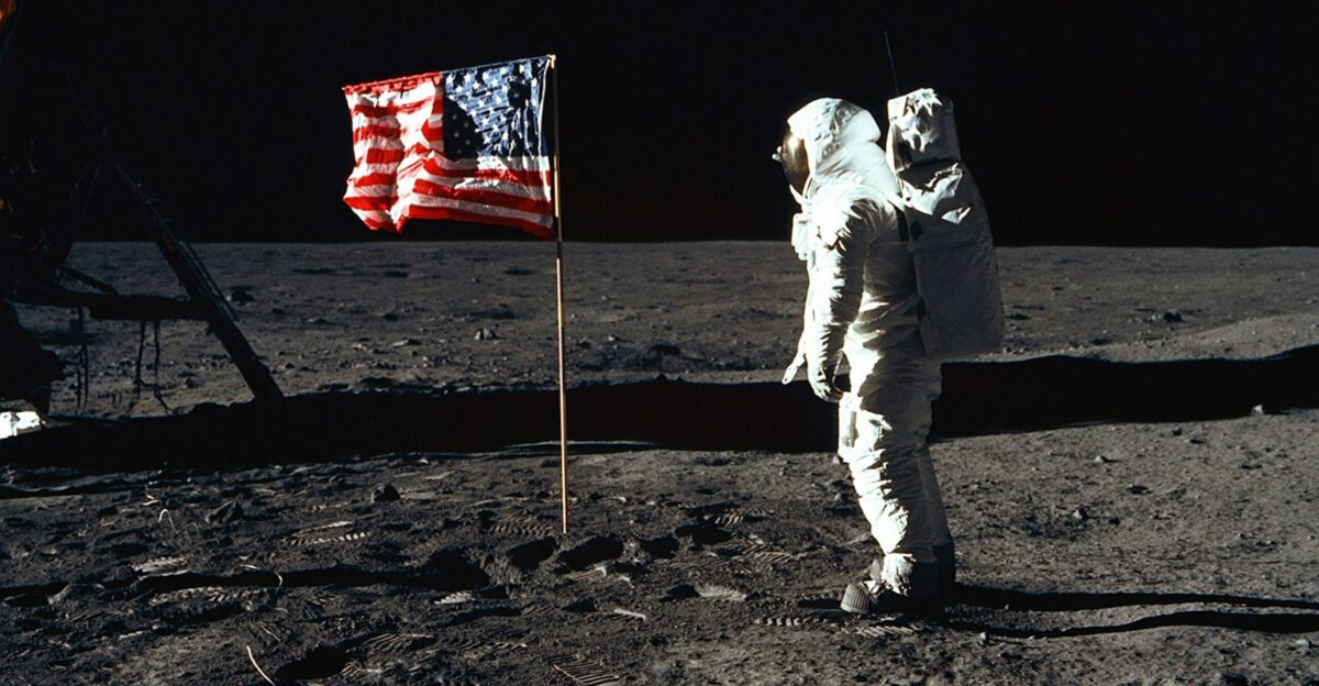 Buzz Aldrin on the moon in front of the US flag