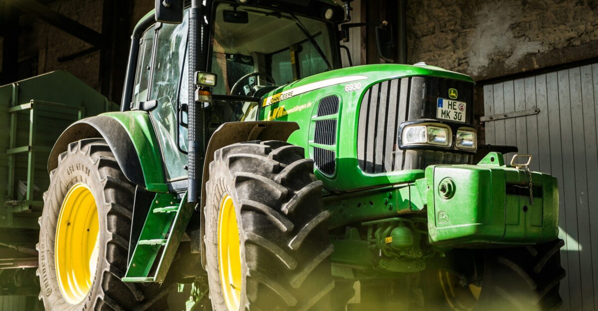 green and yellow tractor in garage