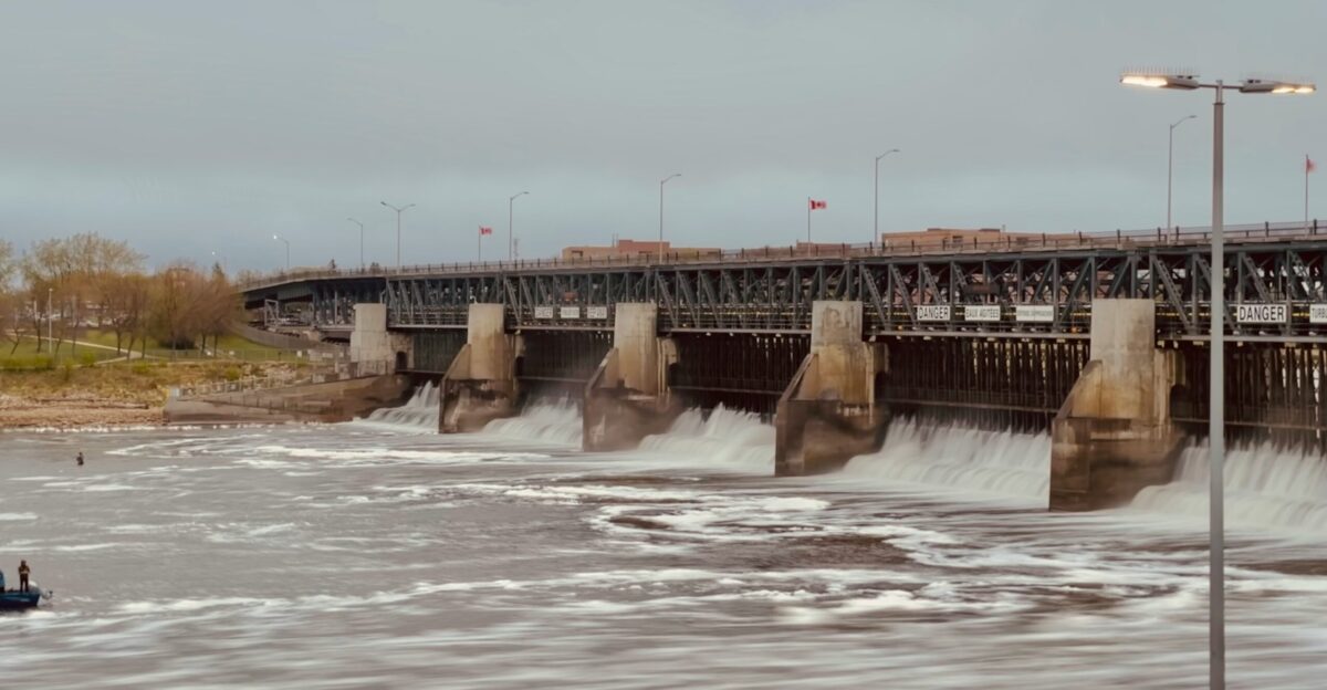 white water dam under white sky during daytime