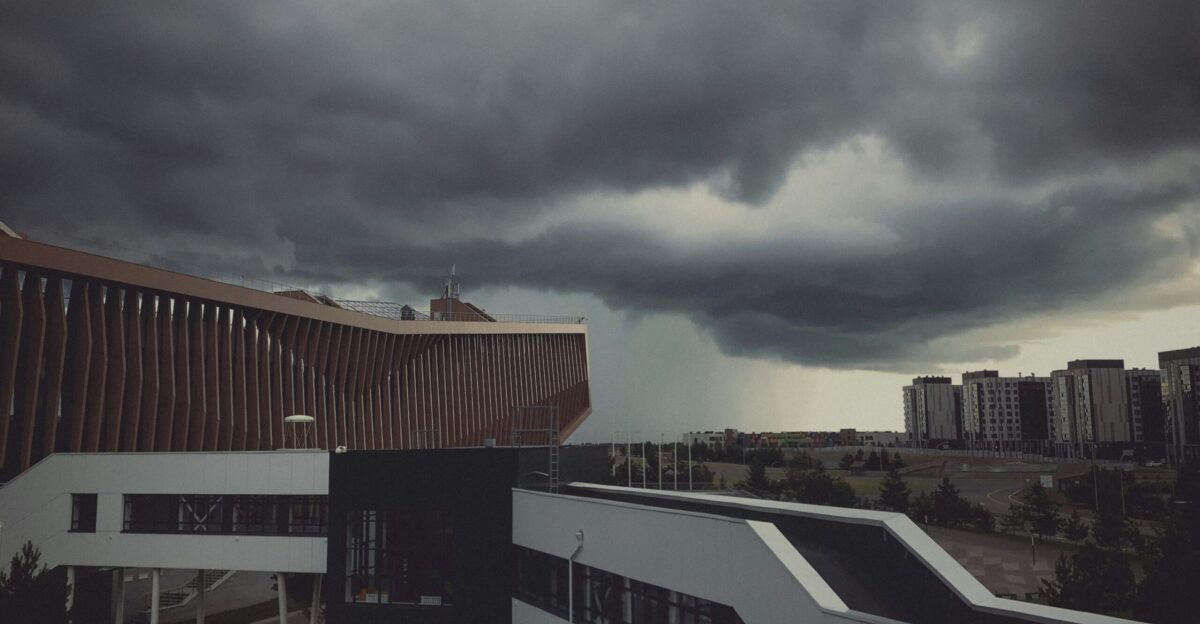 brown and white concrete building under gray clouds