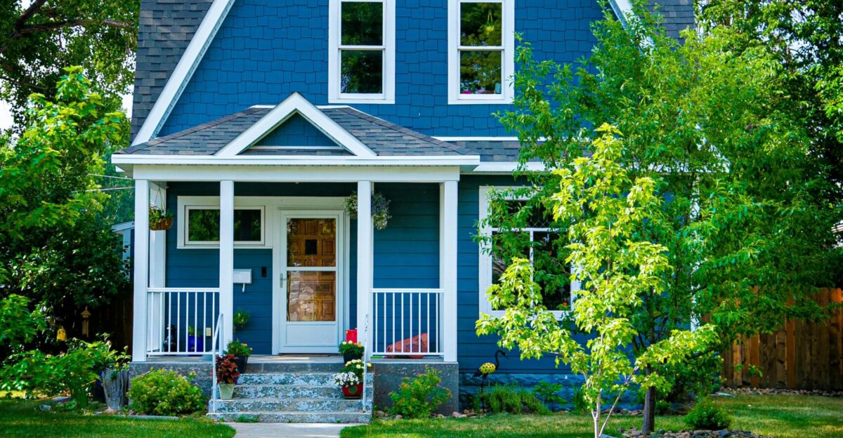 blue and white wooden house near green trees during daytime