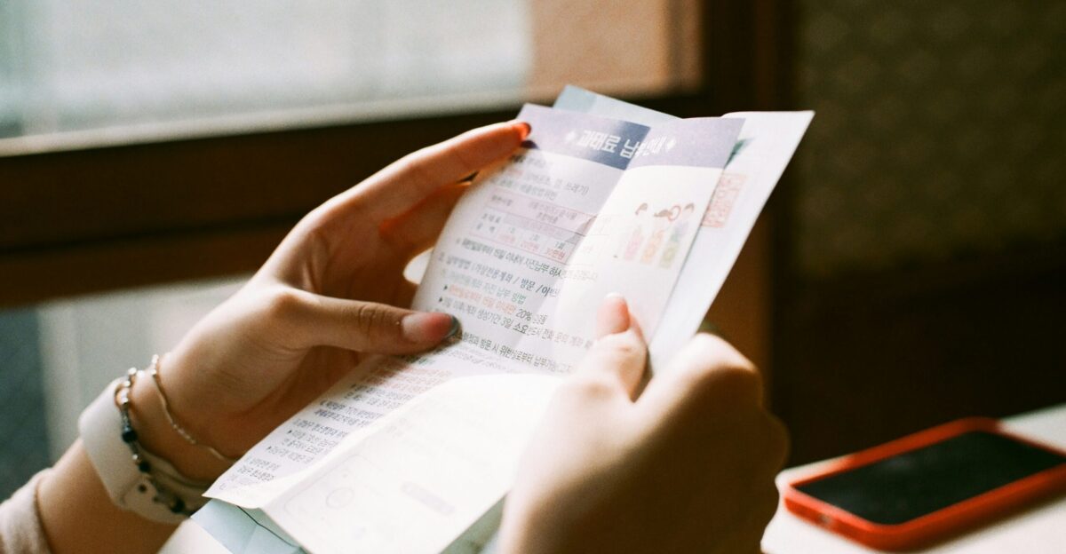 person holding white printer paper