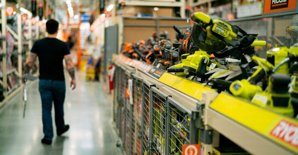 a man is walking down a store aisle