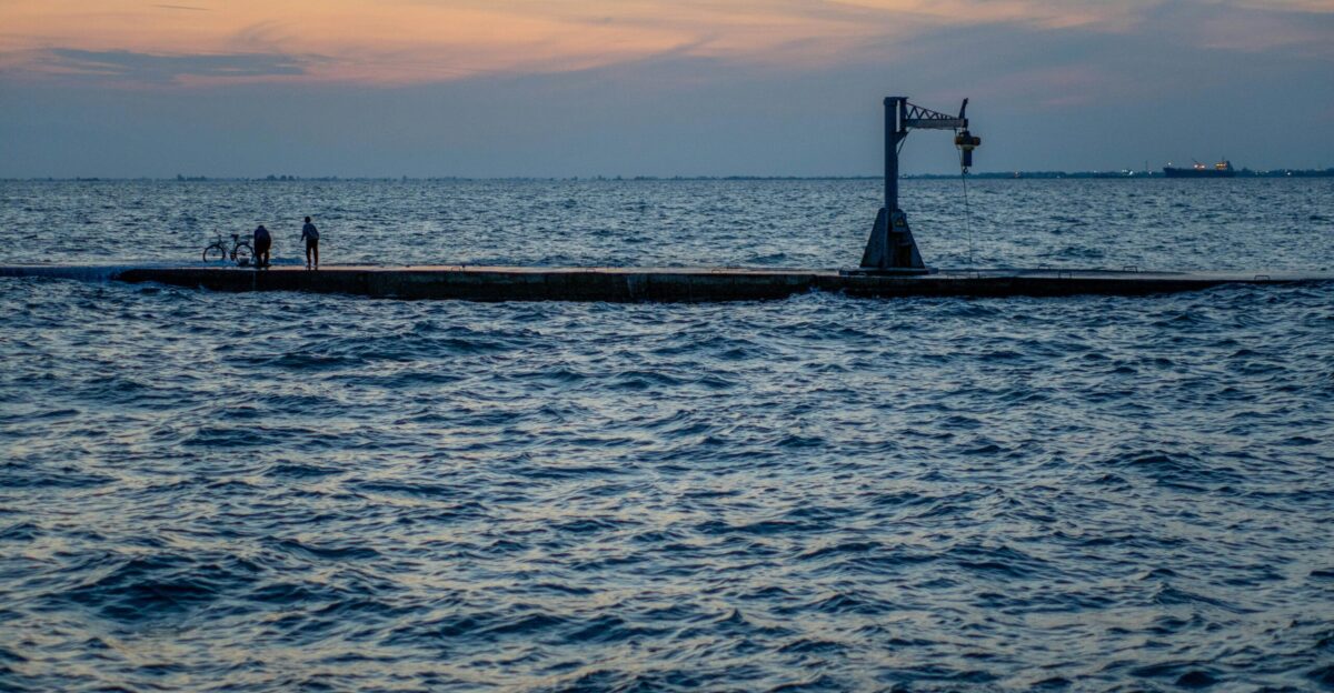 a large body of water with a boat in the distance
