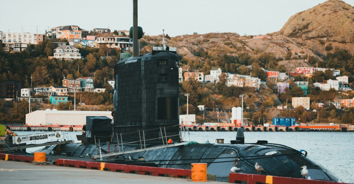 a large black submarine sitting on top of a body of water