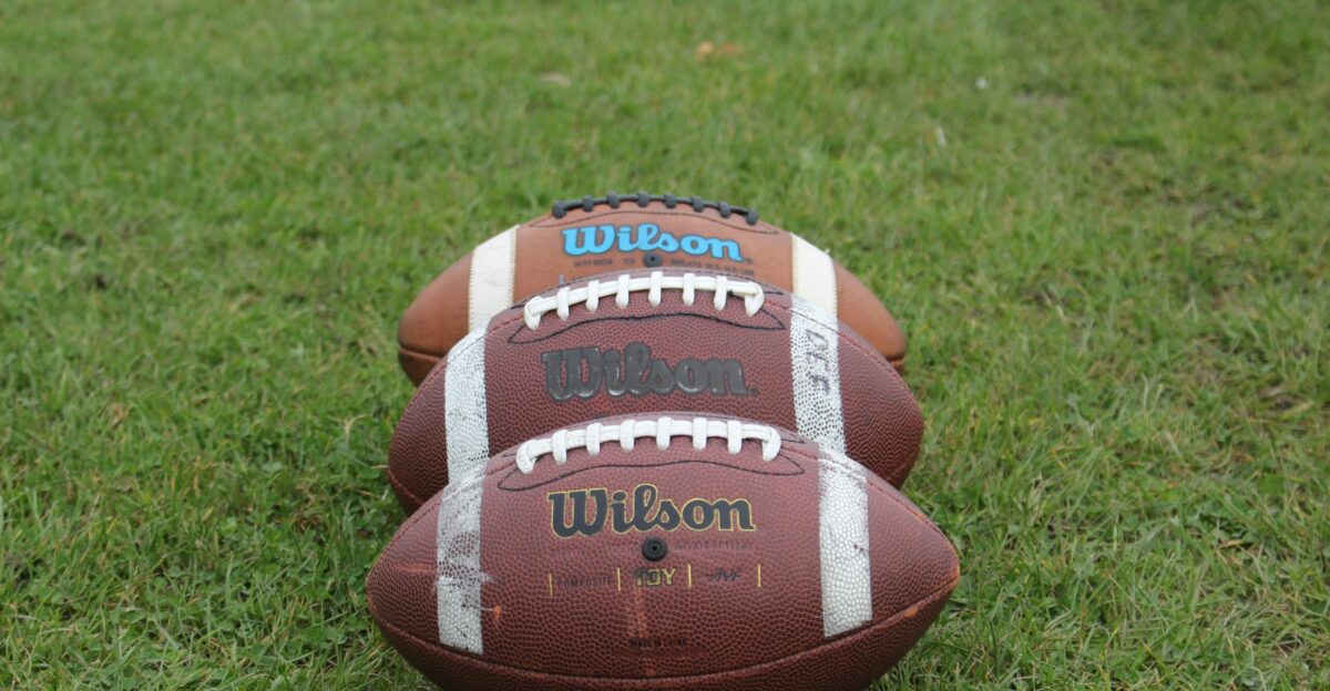 a football laying on top of a lush green field