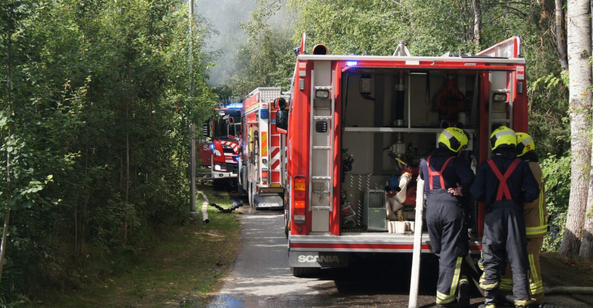 a group of fire fighters standing next to a fire truck
