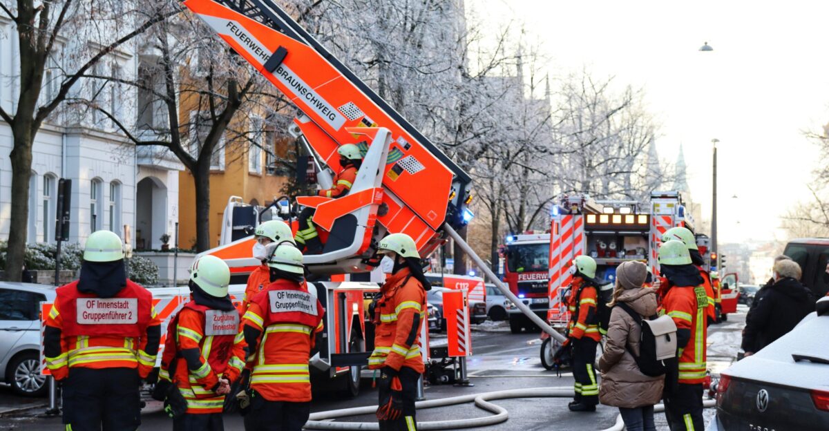 a group of people standing around a fire truck