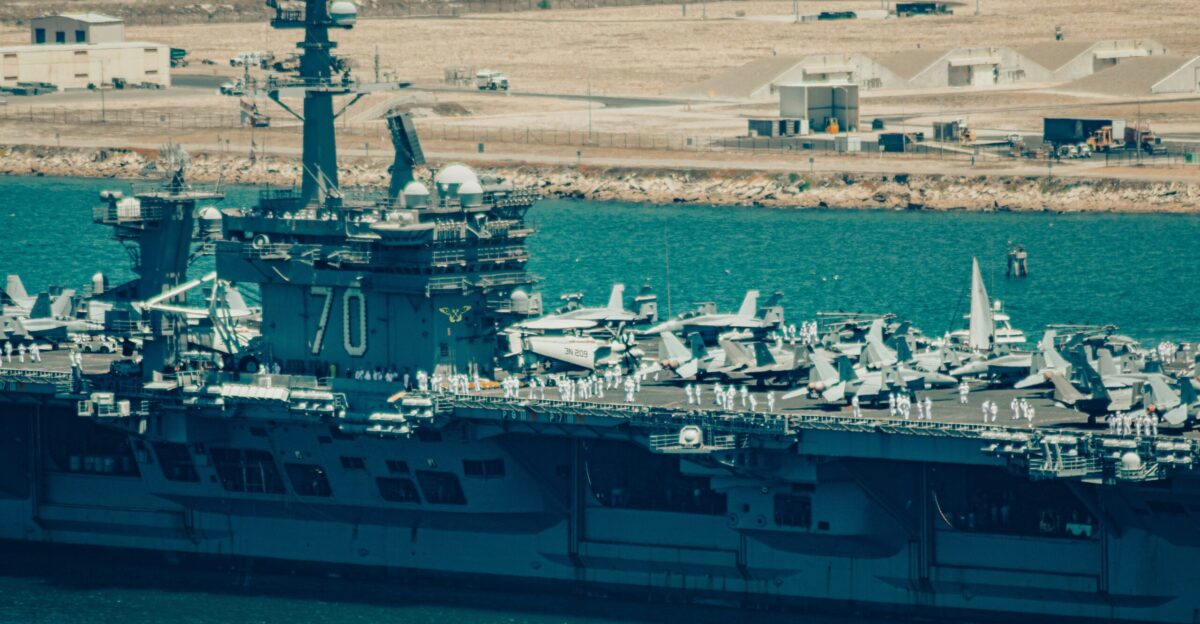 a large navy ship in a body of water