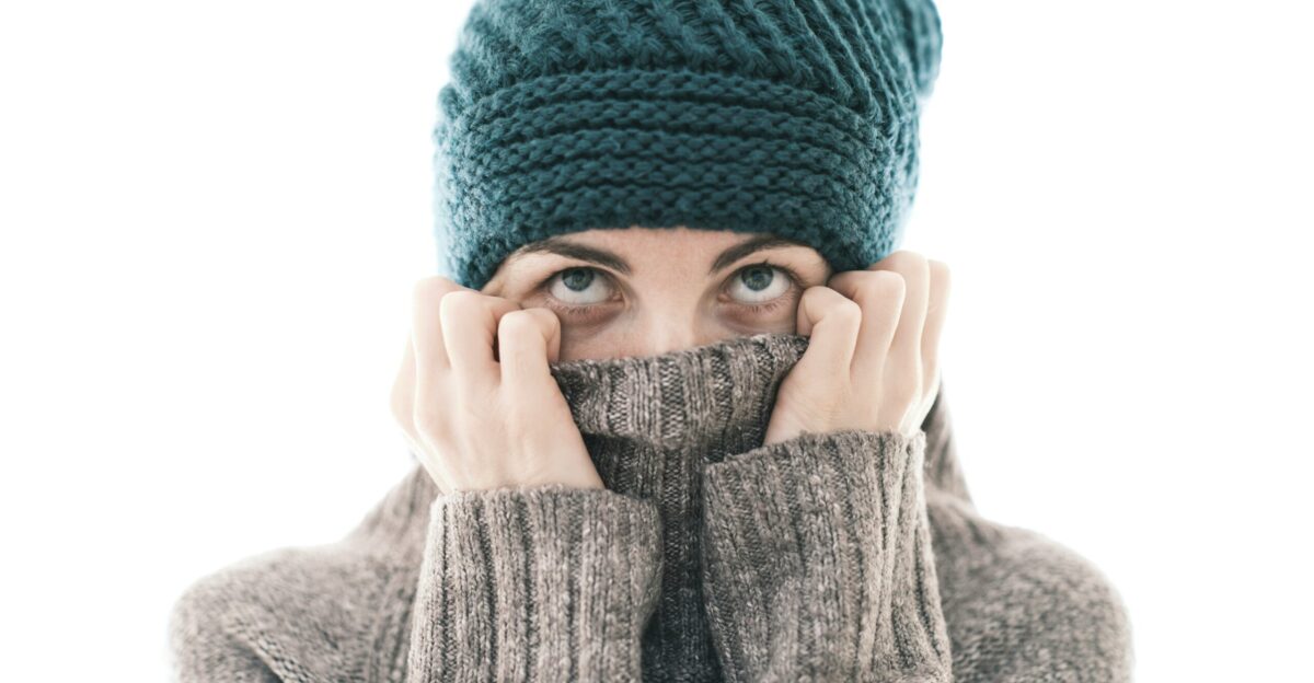 a woman covering her face with her hands