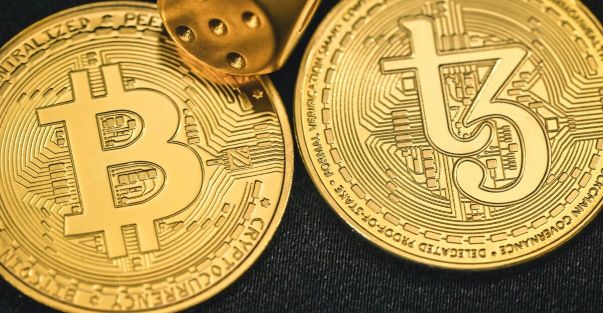 two gold bitcoins sitting next to each other