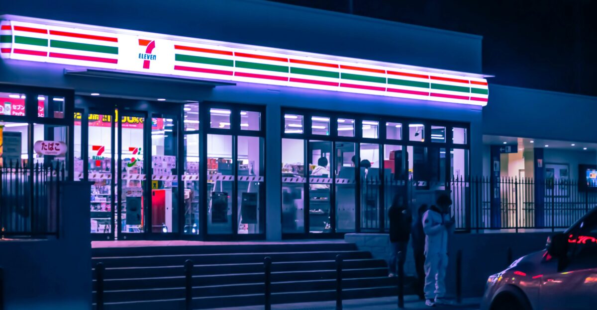 a car parked in front of a store at night