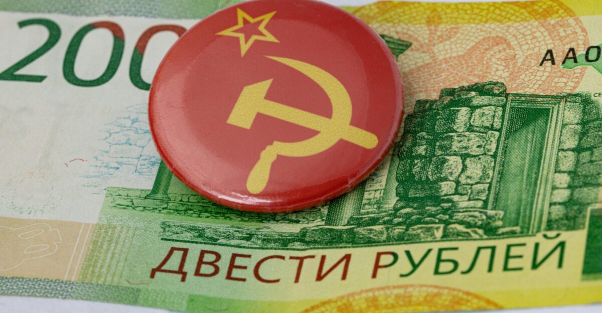 a red button with a hammer and a star on it