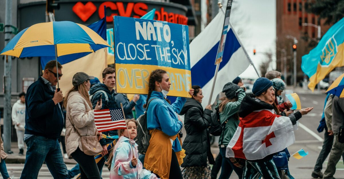 a group of people walking down a street holding umbrellas