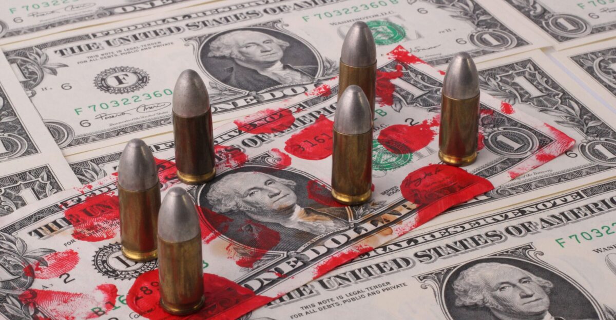 a pile of money with bullet shells on top of it