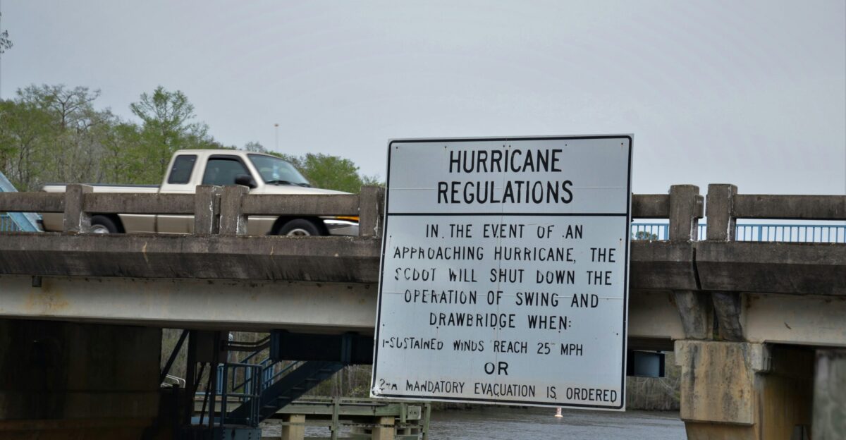 a sign on the side of a bridge warning of hurricanes