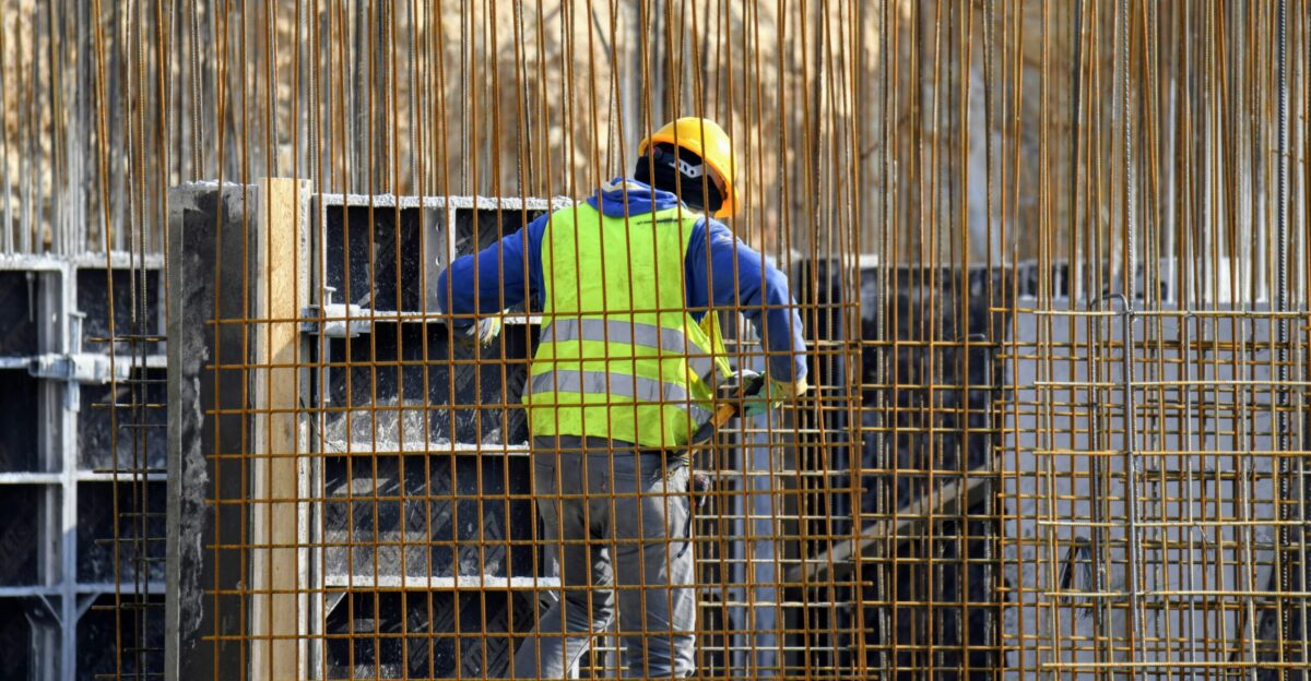 a man in a safety vest working on a construction site